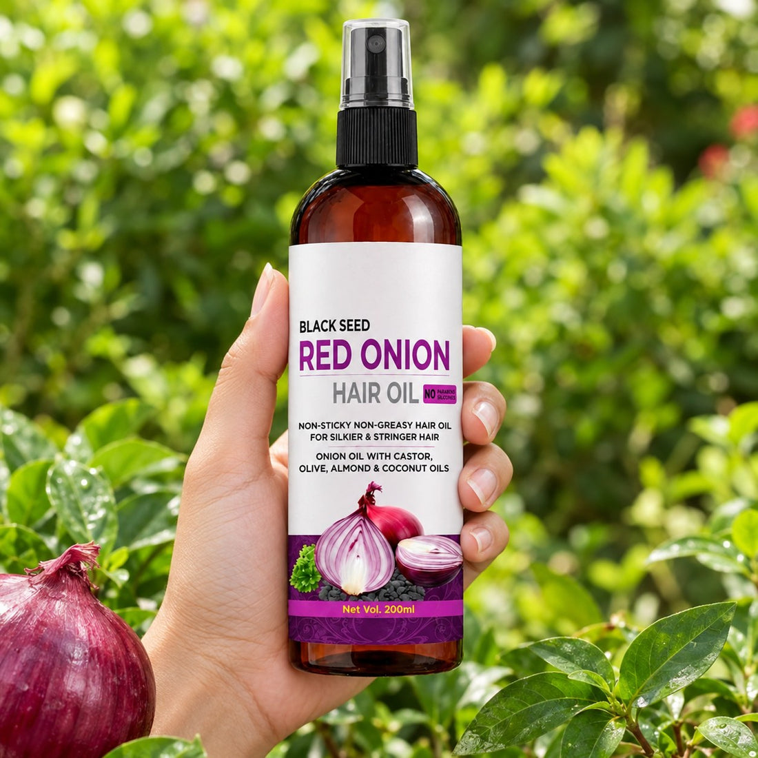 Black Seed Red Onion Hair Oil – held in hand in garden